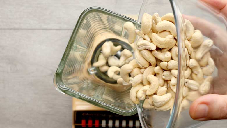 Grinding cashew nuts in a food processor or blender to a fine powder – Kaju Katli Recipe