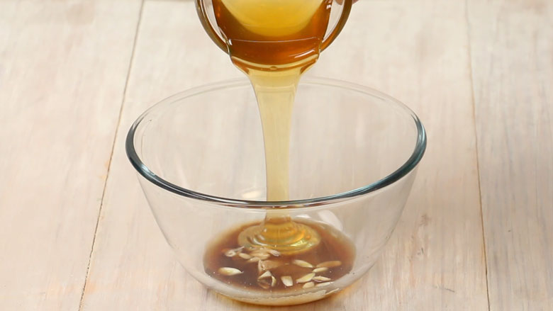 Honey is being poured into a large glass bowl with other honey sauce ingredients – Honey Chicken Recipe