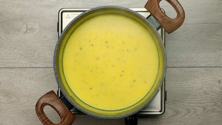 Cook the besan kadhi till slightly thickened - about 20 minutes