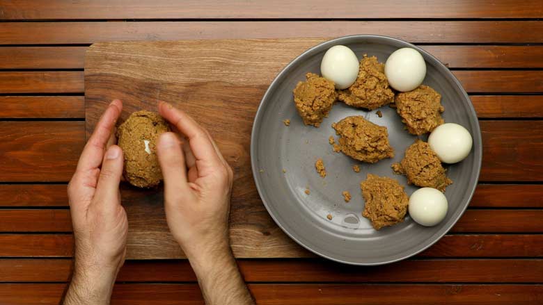 Press mince together with your hands and form a smooth covering for the eggs - Nargisi Kofta Recipe