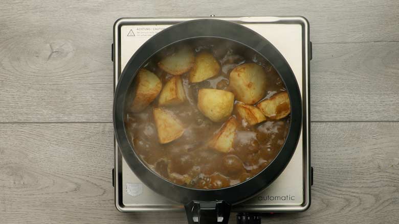 Once the pressure cooker has been opened - add fried potatoes and cook - Hyderabadi Mutton Korma recipe