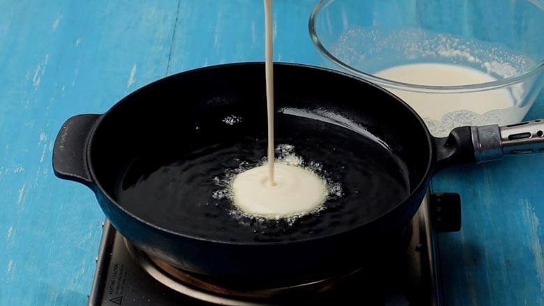 Heat ghee and pour 3 to 4 tbsp batter into the centre of the pan - Malpua Recipe