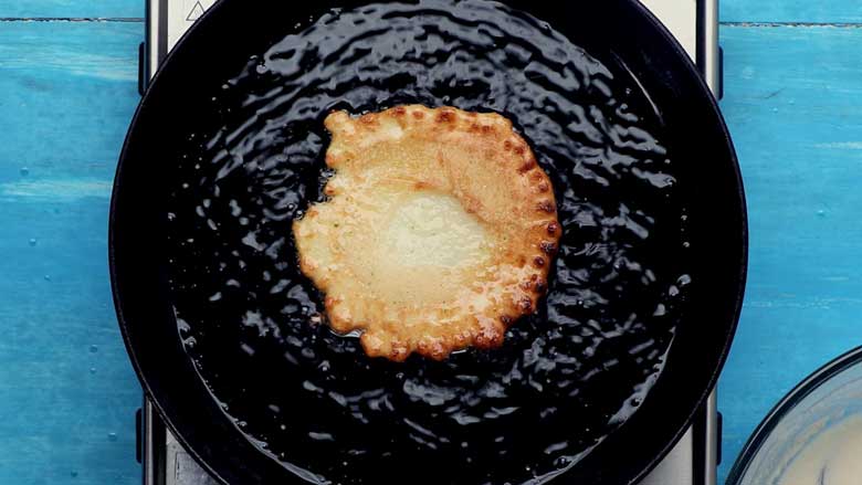 Fry till edges turn golden brown then turn malpua over and fry for another 30 seconds - Malpua Recipe