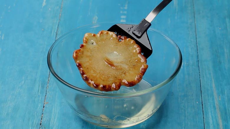 Dip malpua in sugar syrup and allow to soak for 3 to 4 minutes - Malpua Recipe