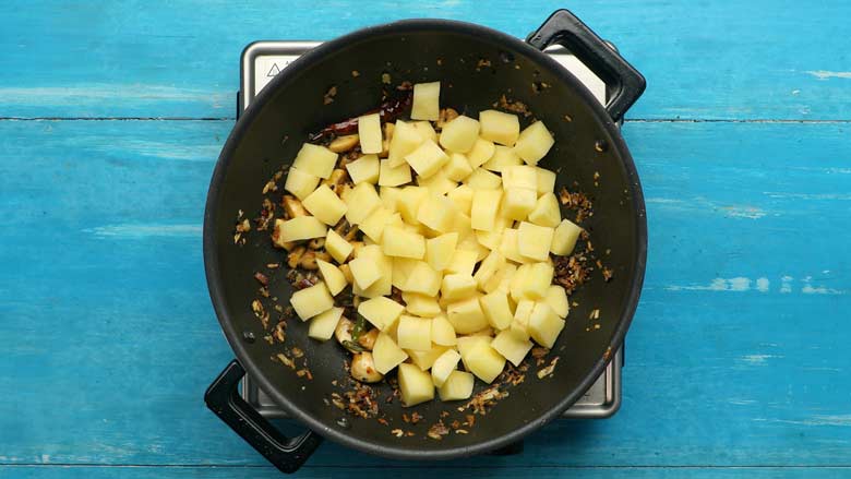 Tip in potatoes and stir for a couple of minutes to coat well with spices - Aloo Mushroom Posto recipe