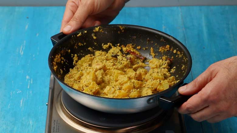 Remove from heat once potatoes are cooked through and most of the liquid has evaporated - Aloo Mushroom Posto recipe