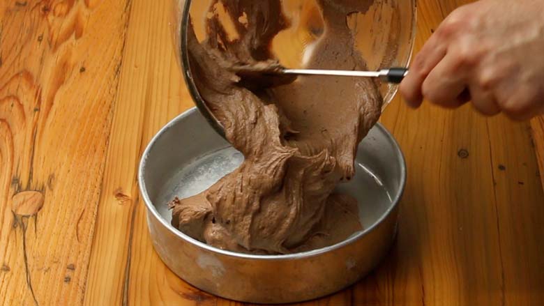 Transfer batter to prepared buttered baking tin and smooth top with a spatula - Cooker Chocolate Cake without Oven Recipe