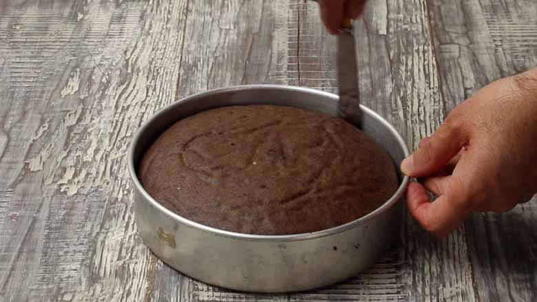 Allow the cake to cool for 10 minutes then run a knife around the edges before inverting it - Cooker Chocolate Cake without Oven Recipe