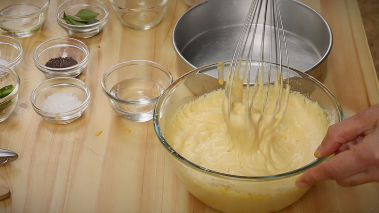 Quickly whisk after adding eno fruit salt and 1 tablespoon water. The batter will double in size - Khaman Dhokla Recipe
