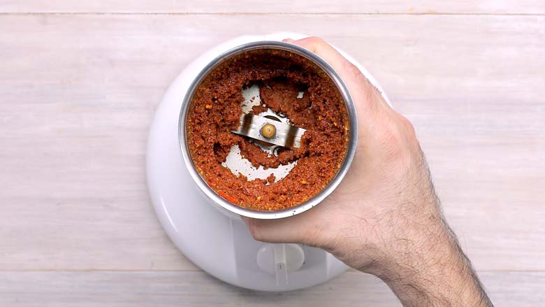 Run stir fried coconut and other ingredients in the grinder to make the sukha masala (red garlic chutney) - Vada Pav Recipe