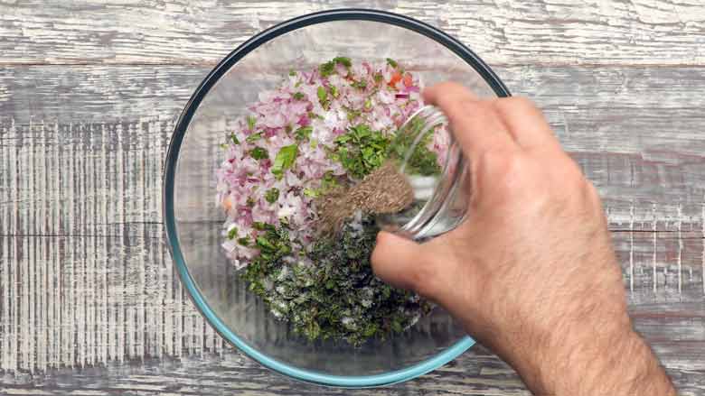 Add pepper, salt, and lime juice - Kachumber Salad Recipe