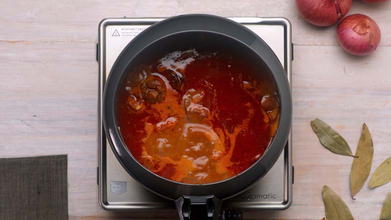 Pour in water, mix well and transfer to a pressure cooker - Rogan Josh Recipe