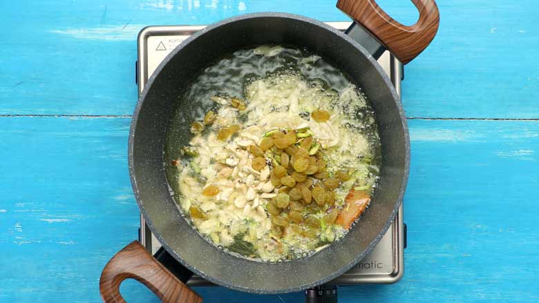 Saute cardamom, cinnamon, almonds, pistachio, cashew nuts, and raisins in the ghee - Zarda Pulao Recipe