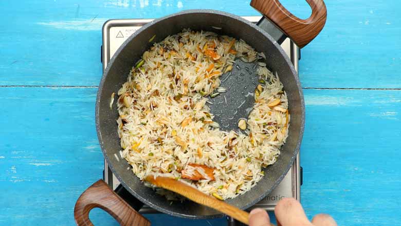 Add rice and stir till well coated with ghee, about 2 minutes - Zarda Pulao Sweet Rice Recipe