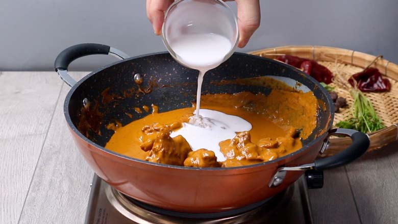 Pour in coconut cream, add pandan leaf, and stir through before removing from heat. Allow to rest for 20 to 30 minutes - Khao Soi Recipe - Chiang Mai Curried Noodles