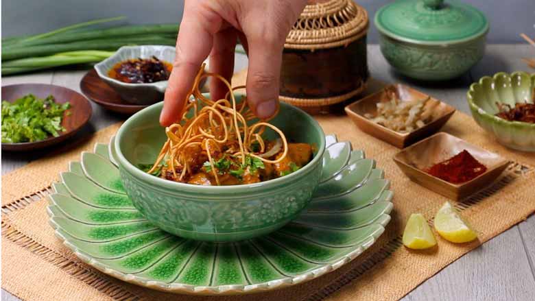 Top with crispy fried noodles and fried and fresh red chillies. Serves with wedges of lime and extra garnishes on the side - Khao Soi Recipe - Chiang Mai Curried Noodles