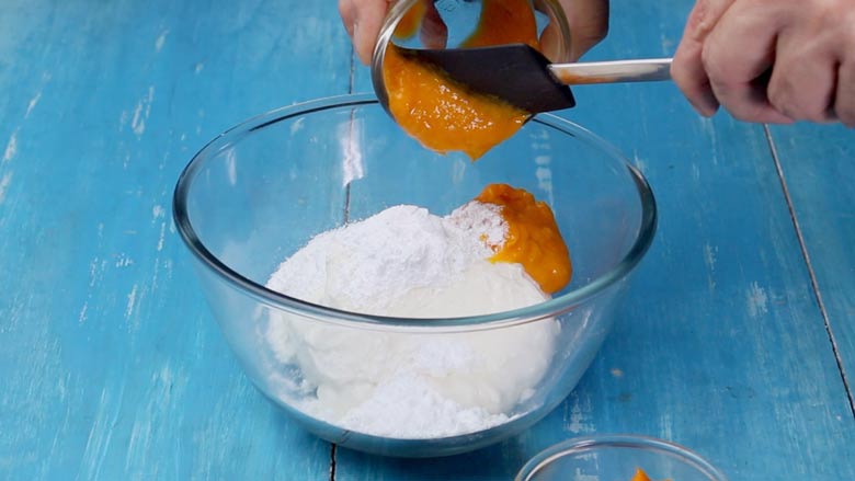 Add fresh pureed mango to the thick hung yogurt (curd) a little at a time - Mango Shrikhand Recipe