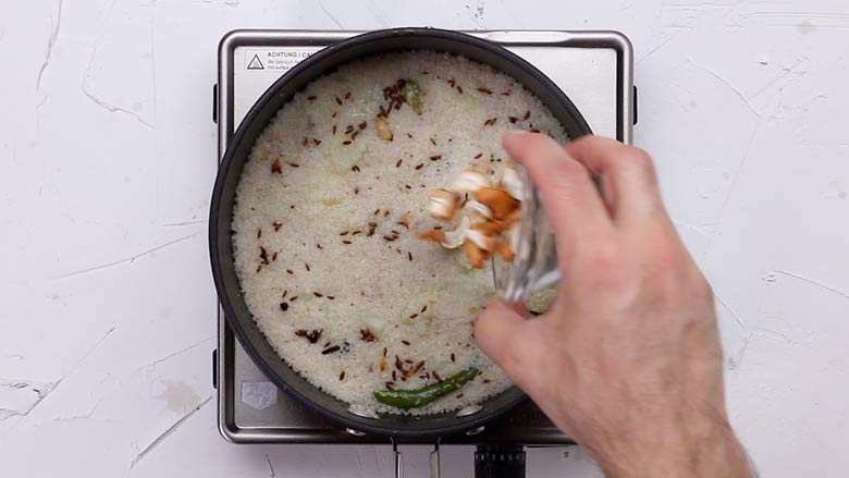Once water is absorbed and sama rice is cooked, add fried cashew nuts and fluff with a fork - Vrat ke Chawal - Samak Rice recipe for fast