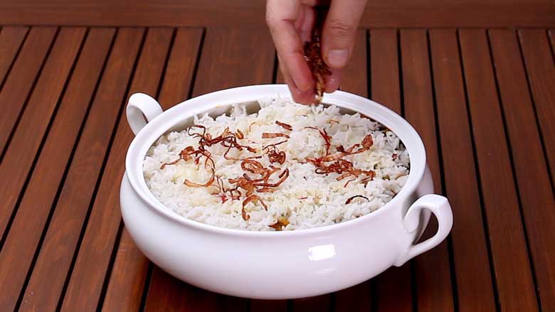 Top with ghee, saffron soaked in milk, and birista (crispy fried onion) and place on dum - Corn Biryani Recipe