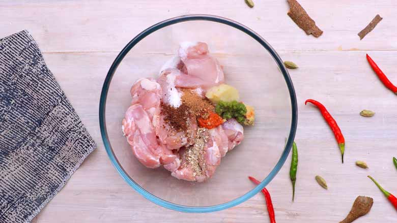 Place boneless chicken thighs in a bowl and add spice powders, salt, ginger, garlic, red chilli, and green chilli - Dum ka Murgh Hyderabad Style Recipe