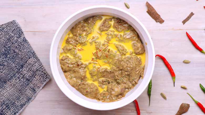 Transfer chicken along with marinade to a baking dish. Add saffron along with the milk in which it was soaked into the chicken and mix well - Dum ka Chicken Recipe