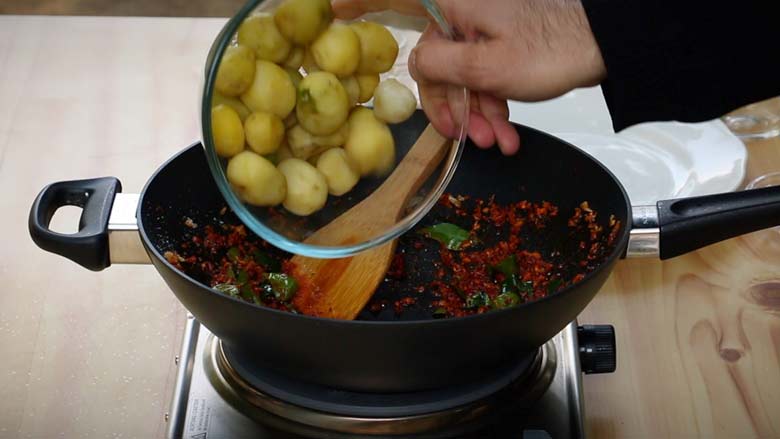Tip in boiled and peeled baby potatoes and sauté -  Masala Baby Potatoes Recipe