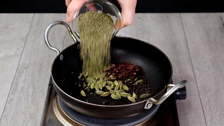 Place a small kadhai over medium heat and add green cardamom pods, cloves, black peppercorns, cinnamon, and fennel seeds - Meat Masala Powder Recipe