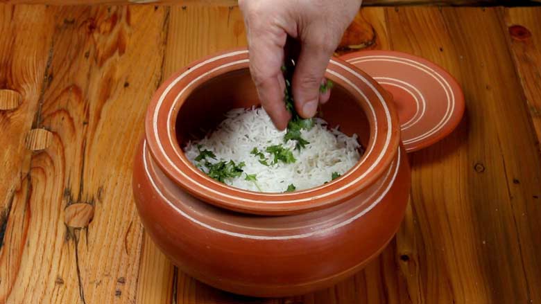 Start layering biryani with masala rice topped with some fresh coriander leaves - Jackfruit Biryani Kathal Biryani Recipe
