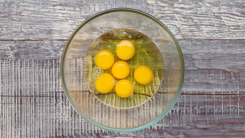 Add 6 eggs to a bowl and beat lightly. Season with salt, chilli powder, and black pepper - Spanish Omelette Recipe