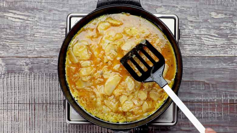 Heat olive oil in a pan or skillet and pour in the egg-potato mixture - Spanish Omelette Recipe