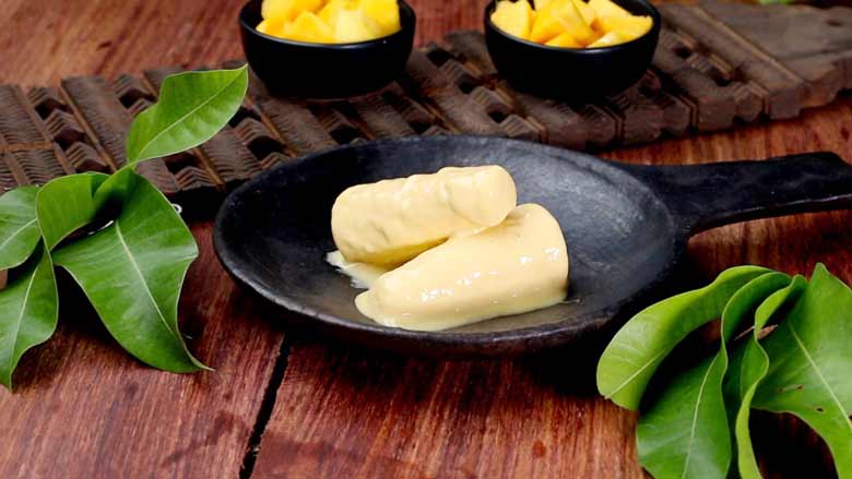 Serve kulfi immediately topped with some diced fresh mango - Mango Kulfi recipe