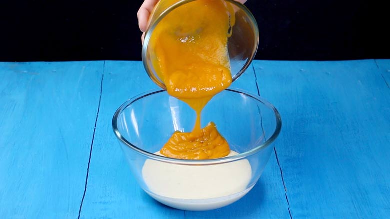 Pour pureed mango into the reduced and sweetened milk - Best Mango Kulfi recipe