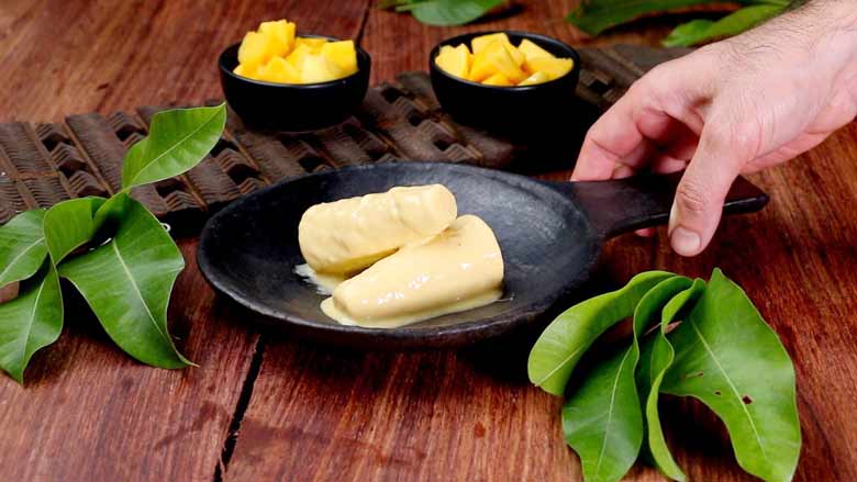 To serve, dip the bottom half of the mould in warm water for 1 to 2 seconds. Then unscrew cap and roll the mould in your palms over a plate so that the mango kulfi slides out - Mango Kulfi recipe