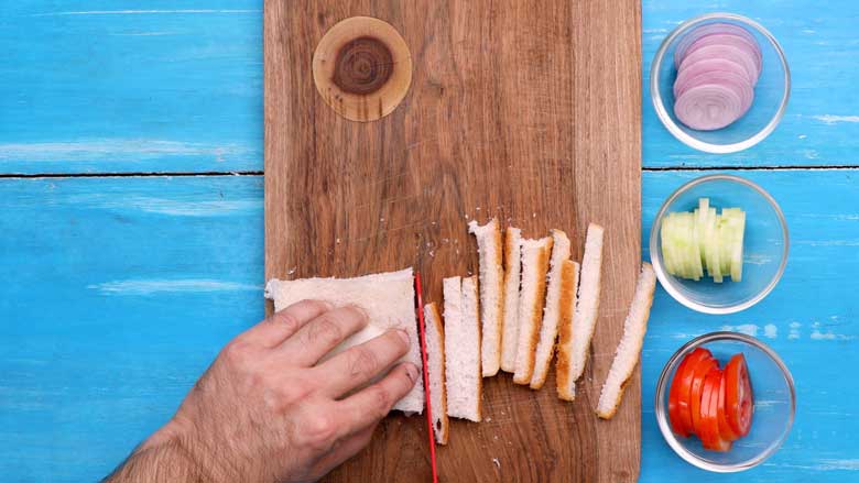 Place slices of bread on a wooden board or other clean surface and trim crusts - Bombay Sandwich Recipe