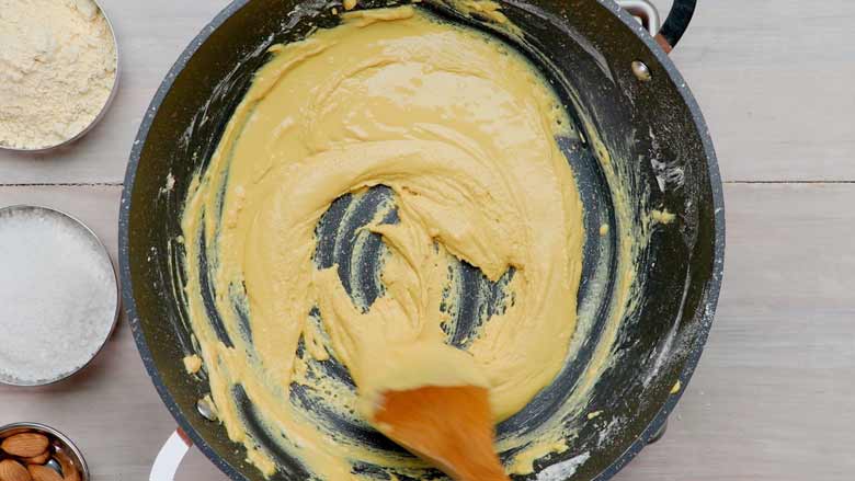 Cook gramflour (besan) and ghee, stirring continuously till lightly coloured, 20 to 25 minutes or less - Besan Ladoo Recipe