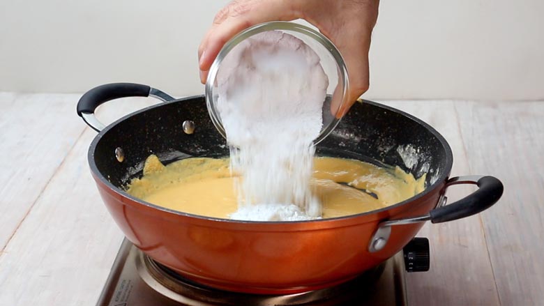 Turn off heat and add sugar and slivered almonds - Besan Ladoo Recipe