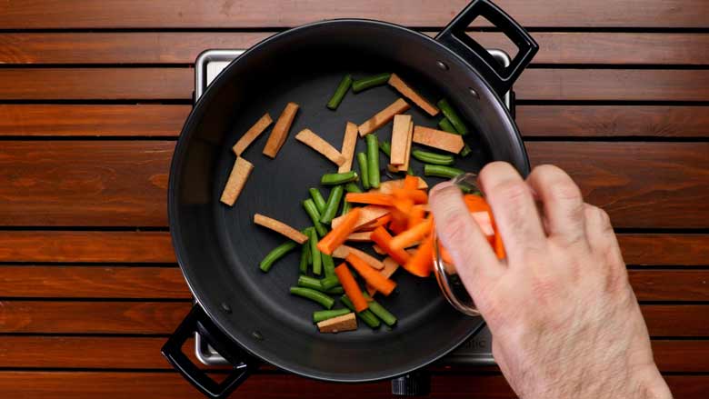  Place a saucepan or chatti on high heat and toss in green beans, yam (jimikand), carrot, potato, brinjal (eggplant), and salt - Avial Mixed Vegetable Curry Recipe