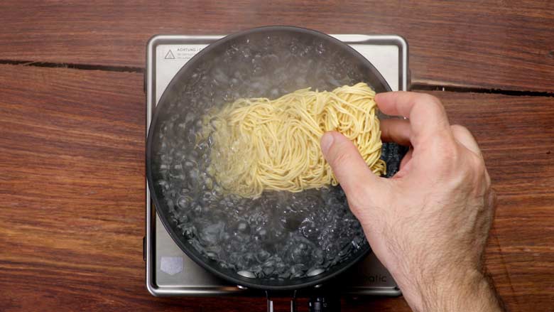 Place hakka noodles in water and boil for 2 to 3 minutes. Drain and toss with 1 tsp oil - Veg Hakka Noodles Recipe