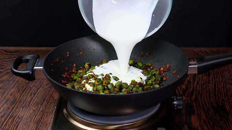 Reduce heat to low and pour in the reserved yogurt–coconut milk mixture - Bhindi Curry Masala Gravy Recipe