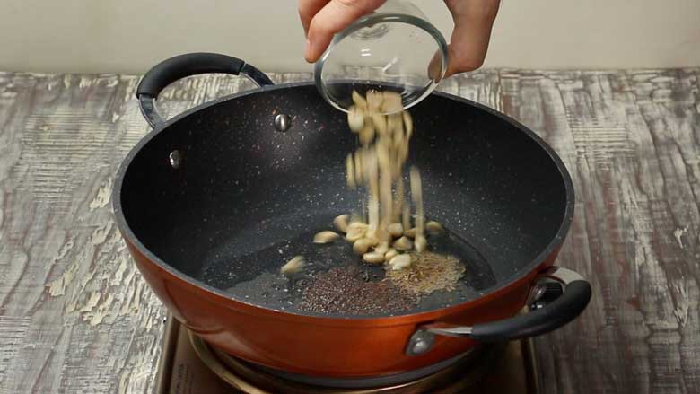 Sauté mustard seeds, cumin seeds, and peanuts in oil till peanuts turn light brown - Indori Poha Recipe