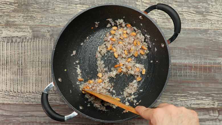 Add onion followed by green chillies and curry leaves, and sauté till golden brown - Indori Poha Recipe
