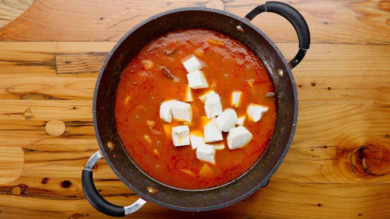 Gently place cubes of paneer in the kadhai - Aloo Paneer Recipe Video