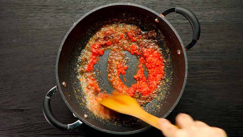 Tip in red chilli paste and stir well - Ambur Biryani Recipe