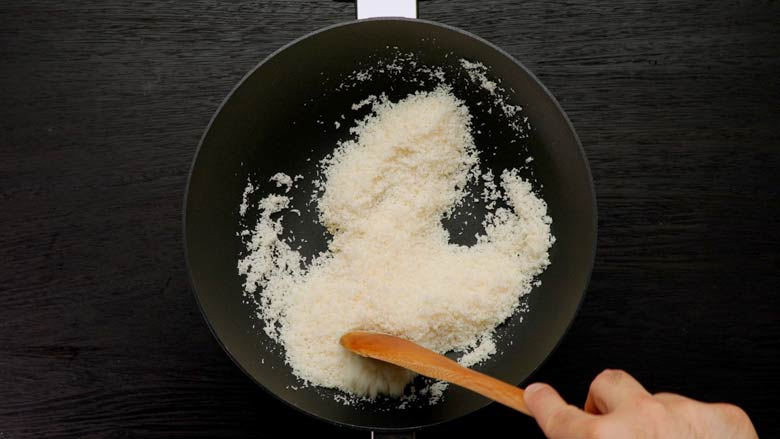 Dry roast the desiccated coconut till aromatic without allowing it to colour - Coconut Ladoo Recipe