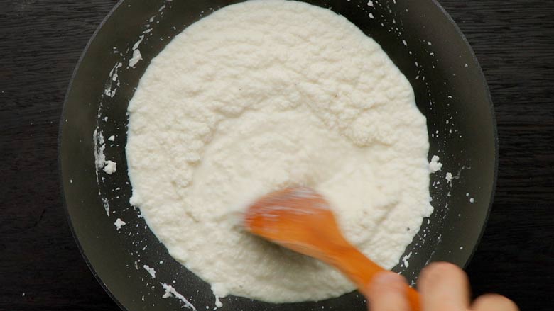 Cook on medium heat till the mixture thickens, then add sugar - Coconut Ladoo Recipe - Nariyal ka Ladoo