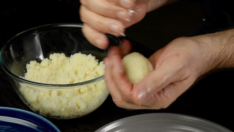 Set mixture aside till cool enough to handle, then roll with ghee greased hands into plum sized balls or ladoos - Coconut Ladoo Recipe