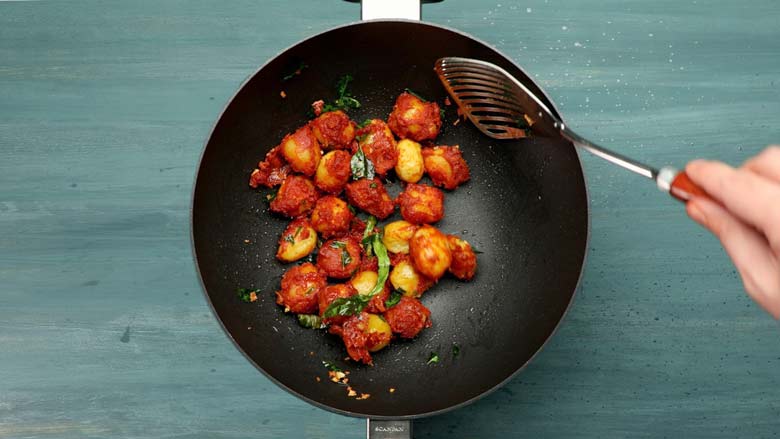 Slide in fried potatoes and toss till well coated with tempering - Potato 65 Recipe