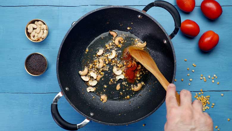 Saute black mustard seeds, cumin seeds, chana dal (Bengal gram), urad dal (black gram), cashew nuts, asafoetida, and red chilli powder in ghee - Tomato Bath Upma Recipe