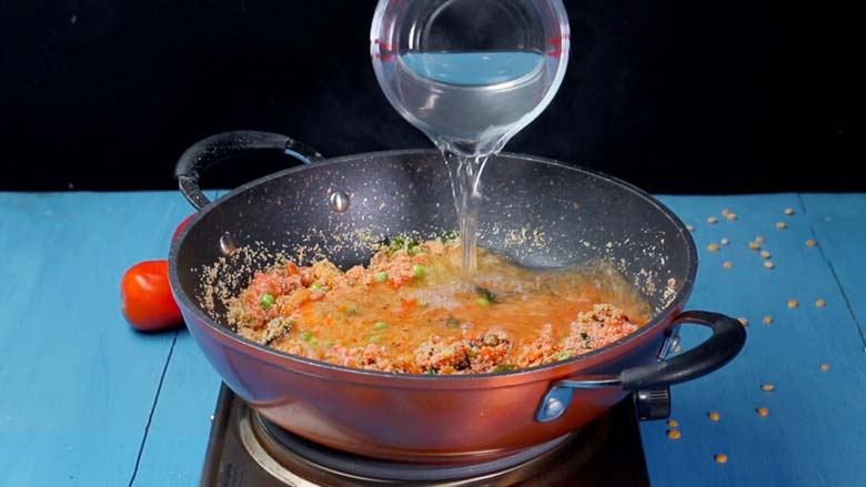 Pour in hot water and stir well - Tomato Bath Upma Recipe