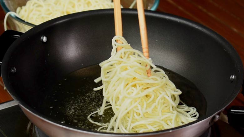 Boil noodles in salted water then fry in hot oil - Veg American Chop Suey Recipe